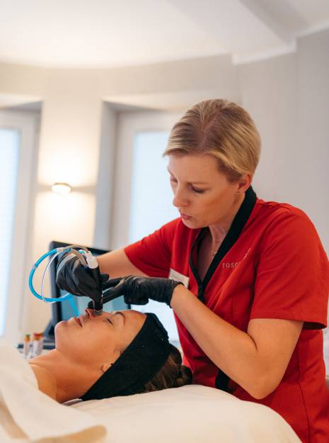 Eine Frau bekommt eine Gesichtsbehandlung als Teil des Medical Wellness im Allgäu.